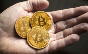 BERLIN, GERMANY - JANUARY 13:  In this photo illustration model Bitcoins lies in a hand on January 13, 2014 in Berlin, Germany. (Photo by Thomas Trutschel/Photothek via Getty Images)